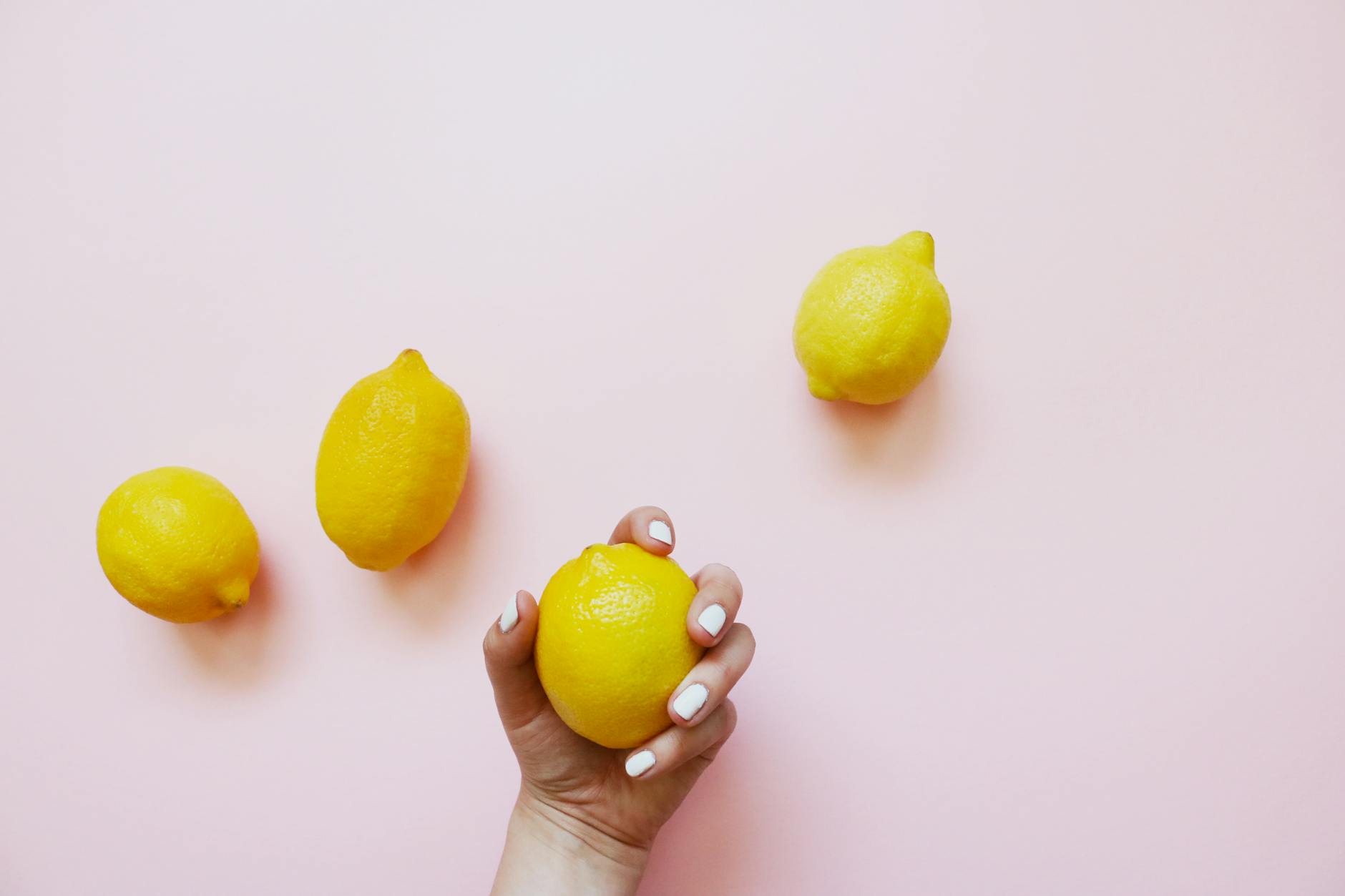 Fresh yellow lemons stacked with books on a white tablecloth, symbolizing readiness and gentle recovery