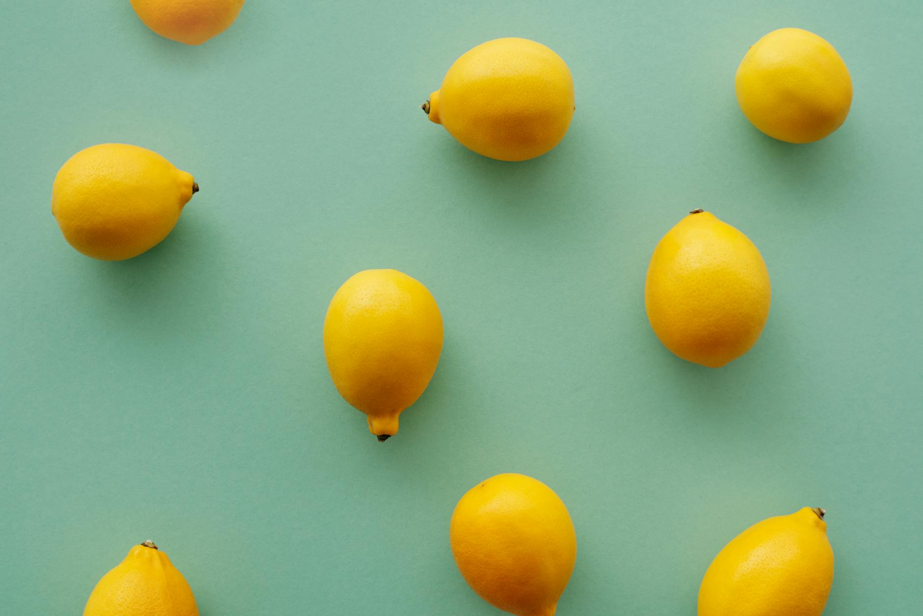 Bright yellow lemons arranged on a pastel background, symbolizing fresh approaches to pleasure and wellness