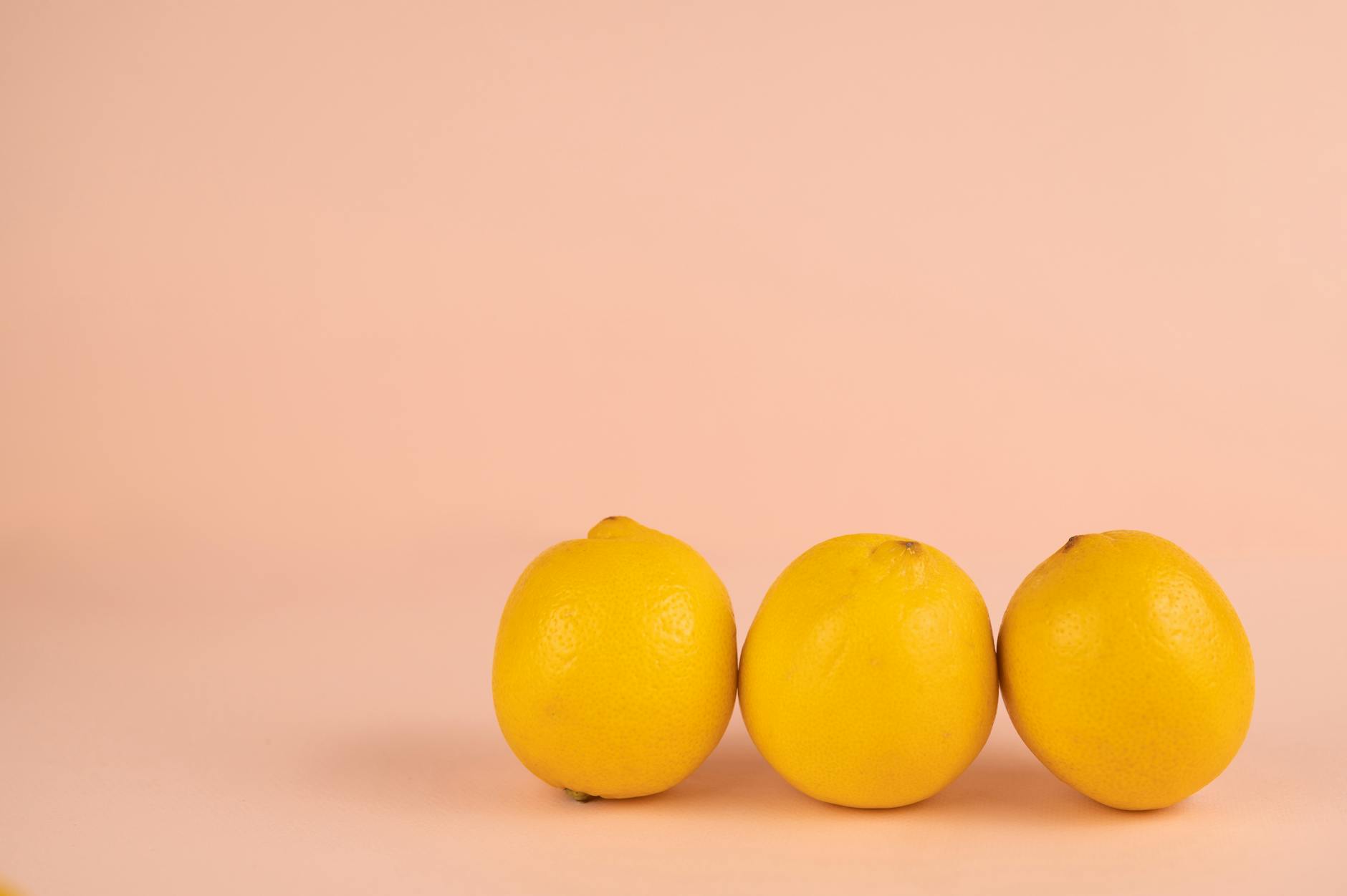 Bright ripe yellow lemons on a pastel background symbolizing renewed sensation and freshness